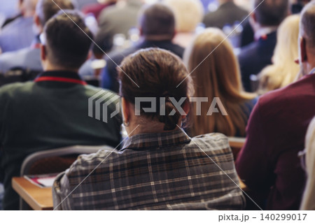 Conference, hall with audience, panel discussion at forum, people on a congress together listen to speaker on stage at convention, plenary session at business lecture seminar, venue for presentation Conference, hall with audience, panel discussion at forum, people on a congress together listen to speaker on stage at convention, plenary session at business lecture seminar, venue for presentation 140299017