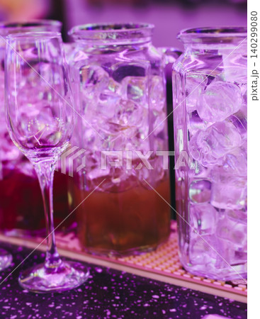 Barman mixing and pouring drinks and beverages, beautiful row line of different coloured lemonades in a jar, liquor alcohol cocktails on a party in bar, catering banquet on event, mocktails in a jug 140299080