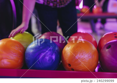 Bowling club play, group team of friends and colleagues playing, throwing a ball on the bowling alley lane, ball and pins, corporate party event in a mall amusement game center, tournament competition Bowling club play, group team of friends and colleagues playing, throwing a ball on the bowling alley lane, ball and pins, corporate party event in a mall amusement game center, tournament competition 140299099
