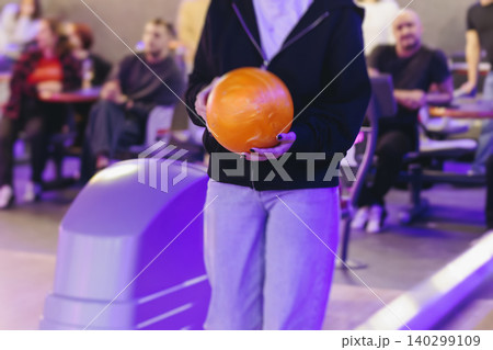 Bowling club play, group team of friends and colleagues playing, throwing a ball on the bowling alley lane, ball and pins, corporate party event in a mall amusement game center, tournament competition 140299109
