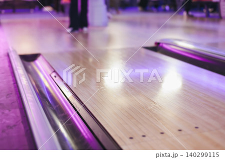Bowling club play, group team of friends and colleagues playing, throwing a ball on the bowling alley lane, ball and pins, corporate party event in a mall amusement game center, tournament competition Bowling club play, group team of friends and colleagues playing, throwing a ball on the bowling alley lane, ball and pins, corporate party event in a mall amusement game center, tournament competition 140299115