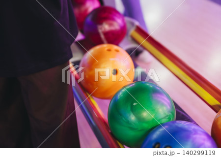 Bowling club play, group team of friends and colleagues playing, throwing a ball on the bowling alley lane, ball and pins, corporate party event in a mall amusement game center, tournament competition Bowling club play, group team of friends and colleagues playing, throwing a ball on the bowling alley lane, ball and pins, corporate party event in a mall amusement game center, tournament competition 140299119