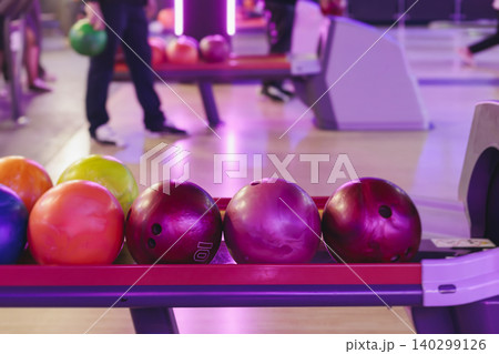 Bowling club play, group team of friends and colleagues playing, throwing a ball on the bowling alley lane, ball and pins, corporate party event in a mall amusement game center, tournament competition Bowling club play, group team of friends and colleagues playing, throwing a ball on the bowling alley lane, ball and pins, corporate party event in a mall amusement game center, tournament competition 140299126