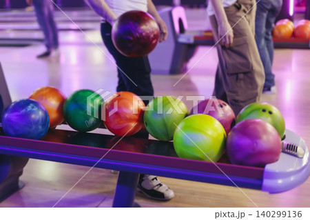 Bowling club play, group team of friends and colleagues playing, throwing a ball on the bowling alley lane, ball and pins, corporate party event in a mall amusement game center, tournament competition 140299136