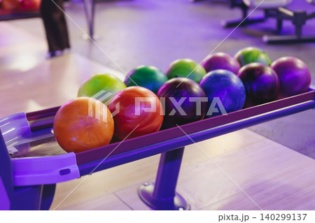 Bowling club play, group team of friends and colleagues playing, throwing a ball on the bowling alley lane, ball and pins, corporate party event in a mall amusement game center, tournament competition Bowling club play, group team of friends and colleagues playing, throwing a ball on the bowling alley lane, ball and pins, corporate party event in a mall amusement game center, tournament competition 140299137