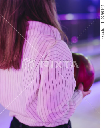 Bowling club play, group team of friends and colleagues playing, throwing a ball on the bowling alley lane, ball and pins, corporate party event in a mall amusement game center, tournament competition 140299141