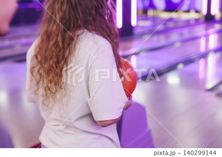 Bowling club play, group team of friends and colleagues playing, throwing a ball on the bowling alley lane, ball and pins, corporate party event in a mall amusement game center, tournament competition 140299144