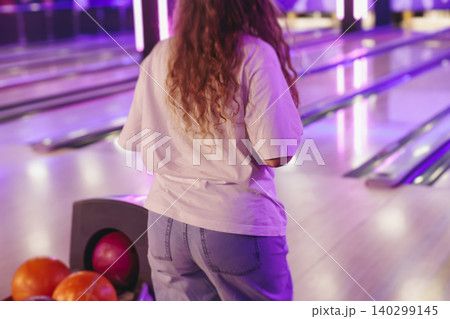 Bowling club play, group team of friends and colleagues playing, throwing a ball on the bowling alley lane, ball and pins, corporate party event in a mall amusement game center, tournament competition 140299145