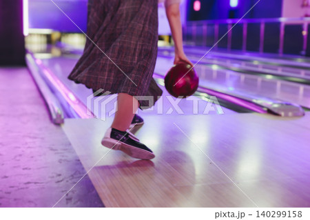 Bowling club play, group team of friends and colleagues playing, throwing a ball on the bowling alley lane, ball and pins, corporate party event in a mall amusement game center, tournament competition Bowling club play, group team of friends and colleagues playing, throwing a ball on the bowling alley lane, ball and pins, corporate party event in a mall amusement game center, tournament competition 140299158