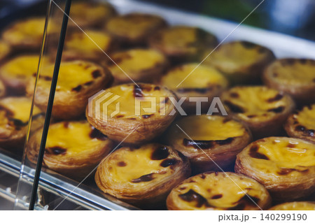 Pasteis and Pastel de nata, traditional Portuguese egg custard tart pasty cakes, dessert Pasteis de nata with different pastry in the cafe, bakery display window, Pastel de belem, Lisbon, Portugal Pasteis and Pastel de nata, traditional Portuguese egg custard tart pasty cakes, dessert Pasteis de nata with different pastry in the cafe, bakery display window, Pastel de belem, Lisbon, Portugal 140299190