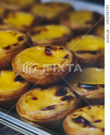 Pasteis and Pastel de nata, traditional Portuguese egg custard tart pasty cakes, dessert Pasteis de nata with different pastry in the cafe, bakery display window, Pastel de belem, Lisbon, Portugal 140299191