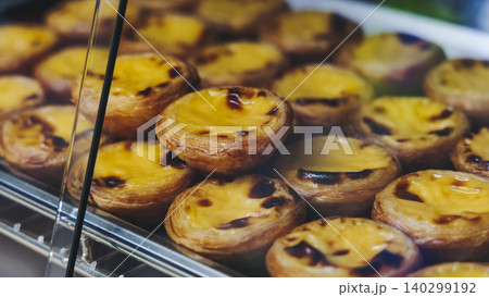 Pasteis and Pastel de nata, traditional Portuguese egg custard tart pasty cakes, dessert Pasteis de nata with different pastry in the cafe, bakery display window, Pastel de belem, Lisbon, Portugal 140299192
