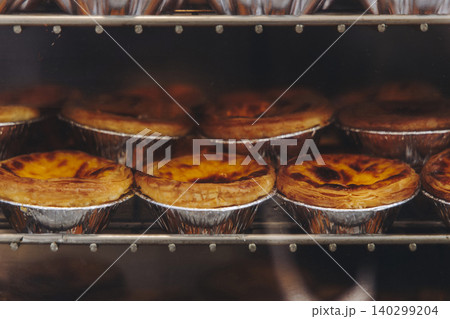 Pasteis and Pastel de nata, traditional Portuguese egg custard tart pasty cakes, dessert Pasteis de nata with different pastry in the cafe, bakery display window, Pastel de belem, Lisbon, Portugal 140299204