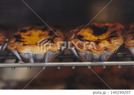 Pasteis and Pastel de nata, traditional Portuguese egg custard tart pasty cakes, dessert Pasteis de nata with different pastry in the cafe, bakery display window, Pastel de belem, Lisbon, Portugal 140299207