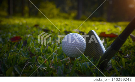 Golf clubs and balls on a green lawn in a beautiful golf course with morning sunshine. Golf clubs and balls on a green lawn in a beautiful golf course with morning sunshine. 140299248