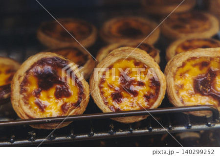 Pasteis and Pastel de nata, traditional Portuguese egg custard tart pasty cakes, dessert Pasteis de nata with different pastry in the cafe, bakery display window, Pastel de belem, Lisbon, Portugal 140299252