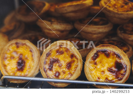 Pasteis and Pastel de nata, traditional Portuguese egg custard tart pasty cakes, dessert Pasteis de nata with different pastry in the cafe, bakery display window, Pastel de belem, Lisbon, Portugal 140299253