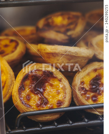 Pasteis and Pastel de nata, traditional Portuguese egg custard tart pasty cakes, dessert Pasteis de nata with different pastry in the cafe, bakery display window, Pastel de belem, Lisbon, Portugal 140299255