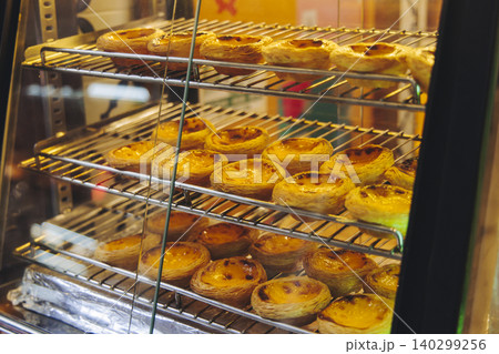 Pasteis and Pastel de nata, traditional Portuguese egg custard tart pasty cakes, dessert Pasteis de nata with different pastry in the cafe, bakery display window, Pastel de belem, Lisbon, Portugal 140299256