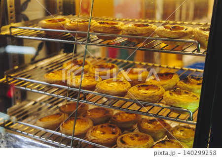 Pasteis and Pastel de nata, traditional Portuguese egg custard tart pasty cakes, dessert Pasteis de nata with different pastry in the cafe, bakery display window, Pastel de belem, Lisbon, Portugal 140299258