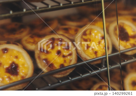 Pasteis and Pastel de nata, traditional Portuguese egg custard tart pasty cakes, dessert Pasteis de nata with different pastry in the cafe, bakery display window, Pastel de belem, Lisbon, Portugal 140299261