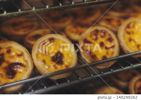 Pasteis and Pastel de nata, traditional Portuguese egg custard tart pasty cakes, dessert Pasteis de nata with different pastry in the cafe, bakery display window, Pastel de belem, Lisbon, Portugal Pasteis and Pastel de nata, traditional Portuguese egg custard tart pasty cakes, dessert Pasteis de nata with different pastry in the cafe, bakery display window, Pastel de belem, Lisbon, Portugal 140299262