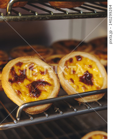 Pasteis and Pastel de nata, traditional Portuguese egg custard tart pasty cakes, dessert Pasteis de nata with different pastry in the cafe, bakery display window, Pastel de belem, Lisbon, Portugal 140299264