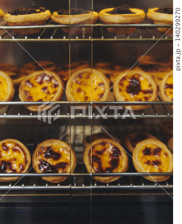 Pasteis and Pastel de nata, traditional Portuguese egg custard tart pasty cakes, dessert Pasteis de nata with different pastry in the cafe, bakery display window, Pastel de belem, Lisbon, Portugal 140299270
