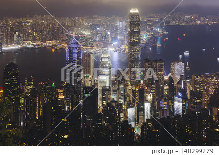 Hong Kong night evening view, China, seen from Victoria Peak observation deck, Lugard road lookout, with Hong Kong downtown skyscrapers and Kowloon island, illuminated city and Victoria Bay at night Hong Kong night evening view, China, seen from Victoria Peak observation deck, Lugard road lookout, with Hong Kong downtown skyscrapers and Kowloon island, illuminated city and Victoria Bay at night 140299279