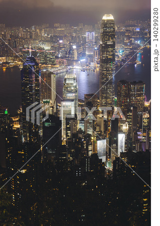 Hong Kong night evening view, China, seen from Victoria Peak observation deck, Lugard road lookout, with Hong Kong downtown skyscrapers and Kowloon island, illuminated city and Victoria Bay at night Hong Kong night evening view, China, seen from Victoria Peak observation deck, Lugard road lookout, with Hong Kong downtown skyscrapers and Kowloon island, illuminated city and Victoria Bay at night 140299280