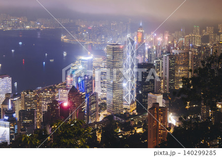 Hong Kong night evening view, China, seen from Victoria Peak observation deck, Lugard road lookout, with Hong Kong downtown skyscrapers and Kowloon island, illuminated city and Victoria Bay at night 140299285
