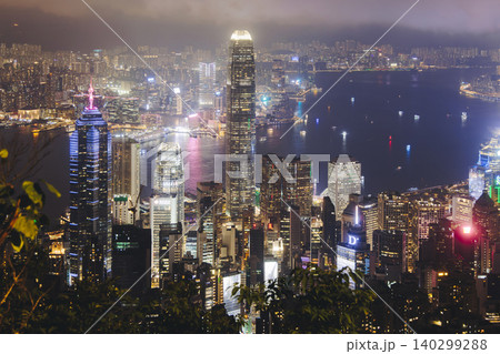 Hong Kong night evening view, China, seen from Victoria Peak observation deck, Lugard road lookout, with Hong Kong downtown skyscrapers and Kowloon island, illuminated city and Victoria Bay at night Hong Kong night evening view, China, seen from Victoria Peak observation deck, Lugard road lookout, with Hong Kong downtown skyscrapers and Kowloon island, illuminated city and Victoria Bay at night 140299288