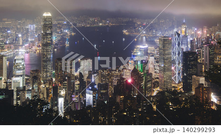 Hong Kong night evening view, China, seen from Victoria Peak observation deck, Lugard road lookout, with Hong Kong downtown skyscrapers and Kowloon island, illuminated city and Victoria Bay at night Hong Kong night evening view, China, seen from Victoria Peak observation deck, Lugard road lookout, with Hong Kong downtown skyscrapers and Kowloon island, illuminated city and Victoria Bay at night 140299293