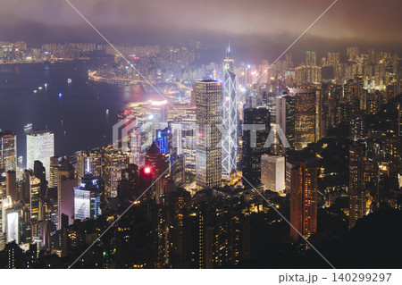 Hong Kong night evening view, China, seen from Victoria Peak observation deck, Lugard road lookout, with Hong Kong downtown skyscrapers and Kowloon island, illuminated city and Victoria Bay at night Hong Kong night evening view, China, seen from Victoria Peak observation deck, Lugard road lookout, with Hong Kong downtown skyscrapers and Kowloon island, illuminated city and Victoria Bay at night 140299297