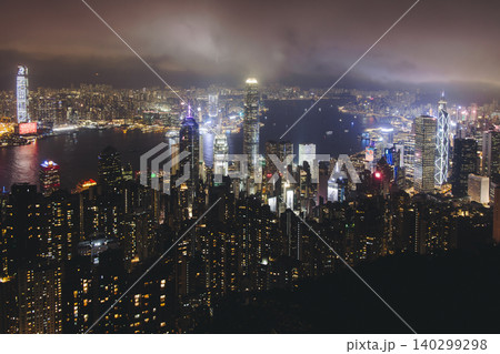 Hong Kong night evening view, China, seen from Victoria Peak observation deck, Lugard road lookout, with Hong Kong downtown skyscrapers and Kowloon island, illuminated city and Victoria Bay at night Hong Kong night evening view, China, seen from Victoria Peak observation deck, Lugard road lookout, with Hong Kong downtown skyscrapers and Kowloon island, illuminated city and Victoria Bay at night 140299298