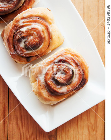 Sweet homemade cinnamon rolls with coffee for breakfast, freshly baked cinnabons with cream cheese. Sweet homemade cinnamon rolls with coffee for breakfast, freshly baked cinnabons with cream cheese. 140299596