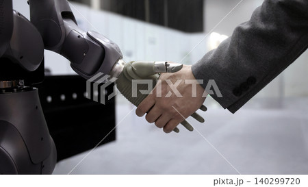 AI Robot shaking hands with man. Close up of human shaking hand with robotic arm. Symbolizing collaborate between people and artificial intelligence or AI. Automation robot innovate future technology AI Robot shaking hands with man. Close up of human shaking hand with robotic arm. Symbolizing collaborate between people and artificial intelligence or AI. Automation robot innovate future technology 140299720