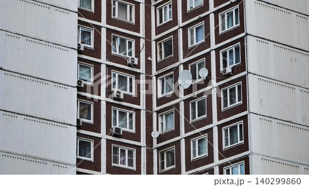Moscow soviet brutalist architecture apartment facade with windows and satellite dishes 140299860