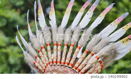 Indian headdress crafted with feathers and fur, symbolizing traditional tribal heritage Indian headdress crafted with feathers and fur, symbolizing traditional tribal heritage 140299902
