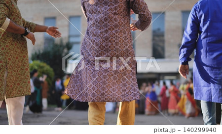 Men wearing traditional kurtas celebrating Ganesh Chaturthi with dancing crowd Men wearing traditional kurtas celebrating Ganesh Chaturthi with dancing crowd 140299940