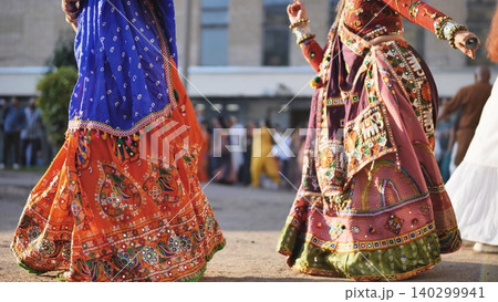 Celebrating Ganesh Chaturthi festival with people dancing Garba in vibrant Indian clothes Celebrating Ganesh Chaturthi festival with people dancing Garba in vibrant Indian clothes 140299941