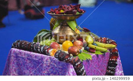 Ganesha festival offerings setup with kalash, flowers, and various fresh fruits 140299959