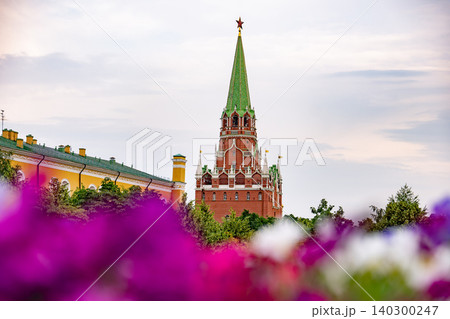 Troitskaya Tower in Moscow Kremlin rising above Alexander Garden flowers 140300247