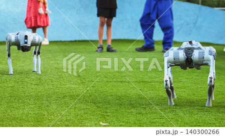Robot dogs interacting with people on artificial grass, symbolizing future technology 140300266
