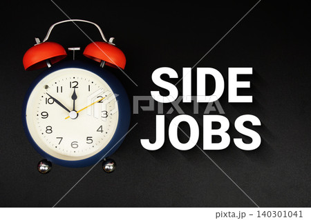 Side Jobs text with alarm clock on black background Side Jobs text with alarm clock on black background 140301041
