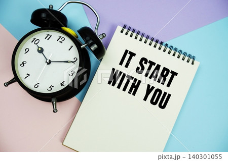 It Start With You text written on notepad with alarm clock flat lay on multicolor pastel background It Start With You text written on notepad with alarm clock flat lay on multicolor pastel background 140301055