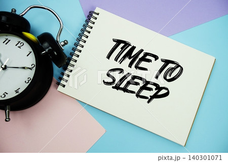Time To Sleep text written on notepad with alarm clock flat lay on multicolor pastel background Time To Sleep text written on notepad with alarm clock flat lay on multicolor pastel background 140301071