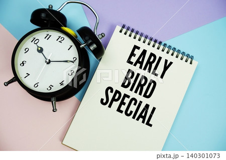 Early Bird Special text written on notepad with alarm clock flat lay on multicolor pastel background Early Bird Special text written on notepad with alarm clock flat lay on multicolor pastel background 140301073