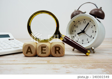 AER Annual Equivalent Rate alphabet letters with magnifying glass, calculator and alarm clock 140301549