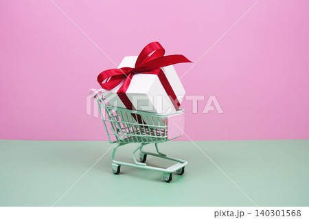 Shopping Cart and Gift Box on pink background with copy space Shopping Cart and Gift Box on pink background with copy space 140301568